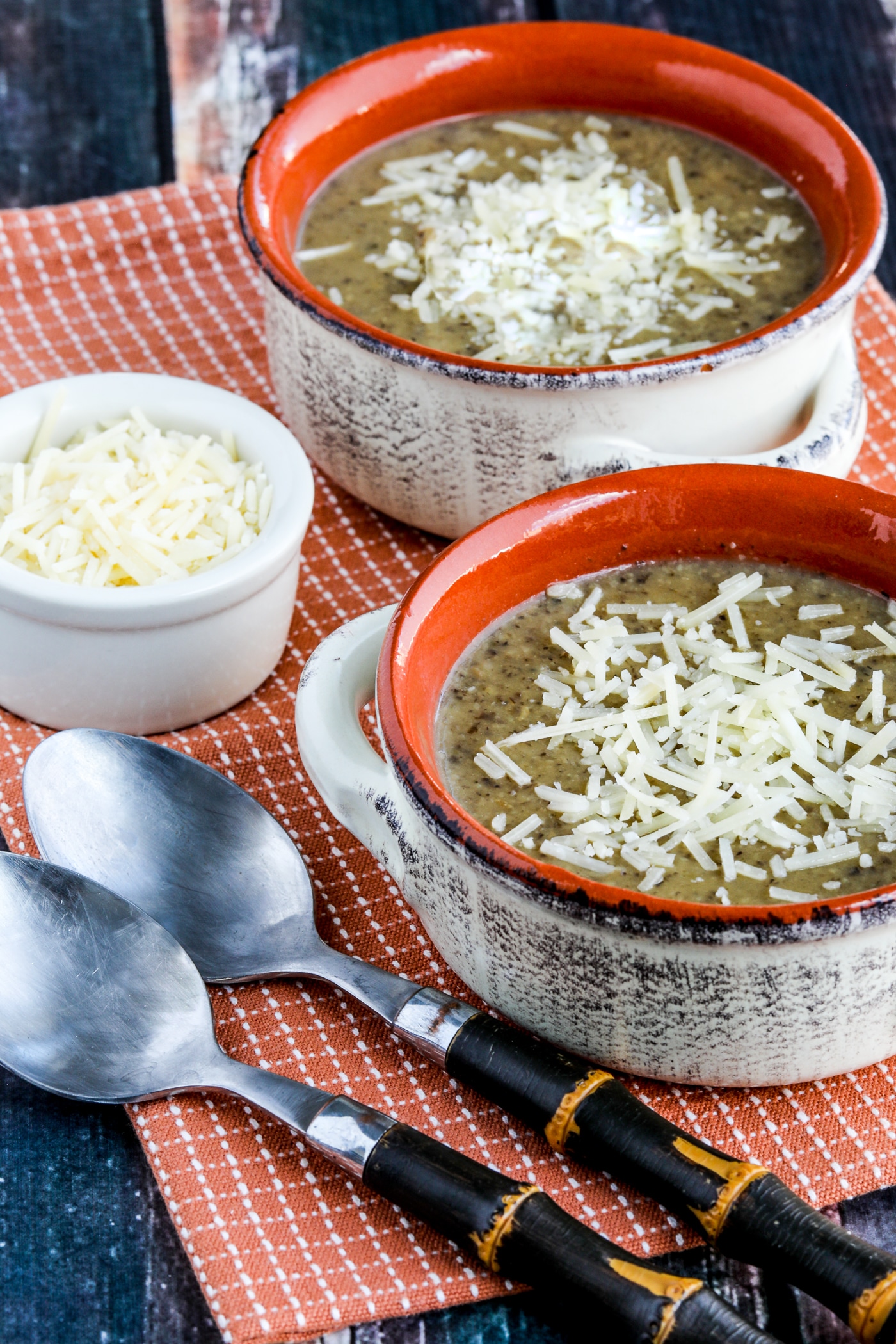 Instant pot cauliflower mushroom soup displayed in two serving bowls garnished with parmesan cheese
