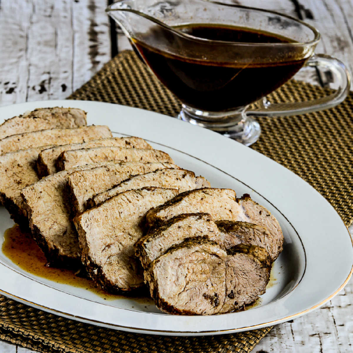 Square image for Slow Cooker Balsamic Pork Roast shown on platter with sauce in back.