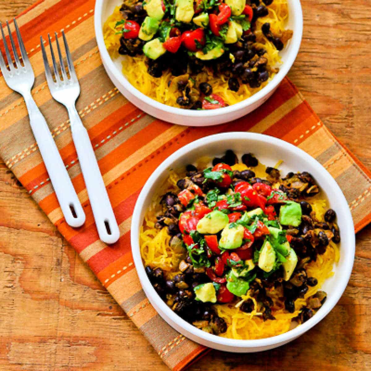 Square image for Spaghetti Squash Burrito Bowl shown in two bowls with forks.