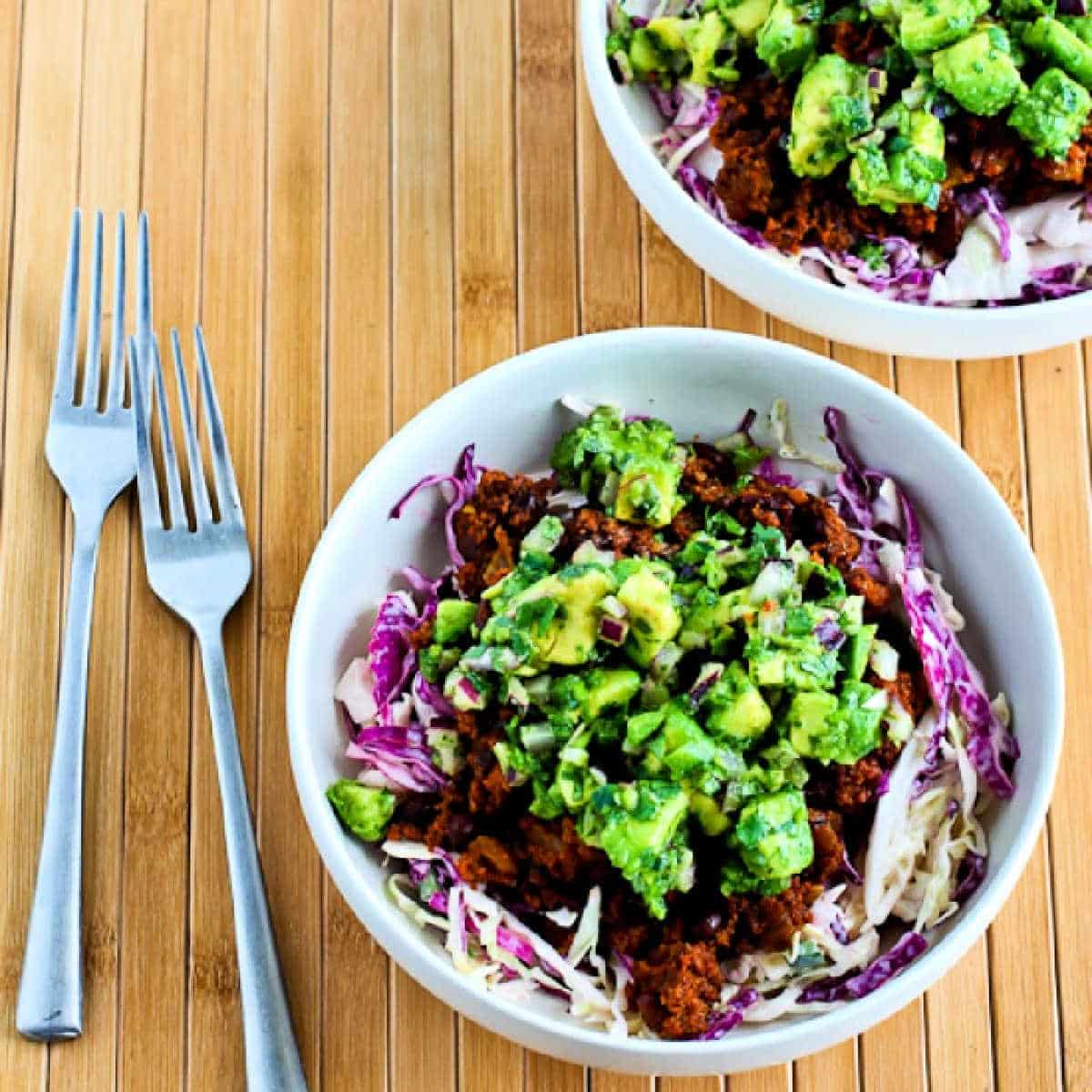 Square image of Ground Turkey Taco Bowls with cabbage and avocado salsa.