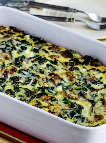 Kale, Mushroom, and Cheese Breakfast Casserole square photo of finished casserole in baking dish.