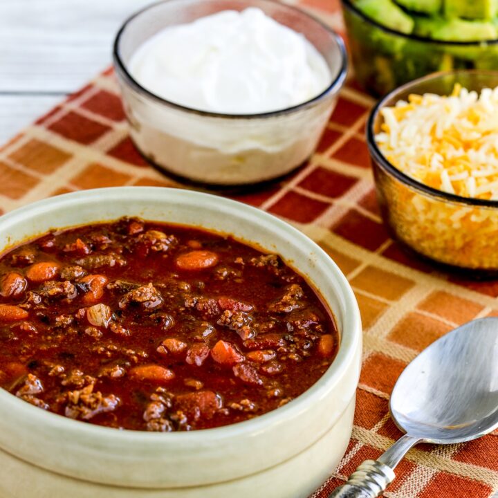 Easy Taco Soup bowl of soup with sour cream, avocado, and grated cheese on the side