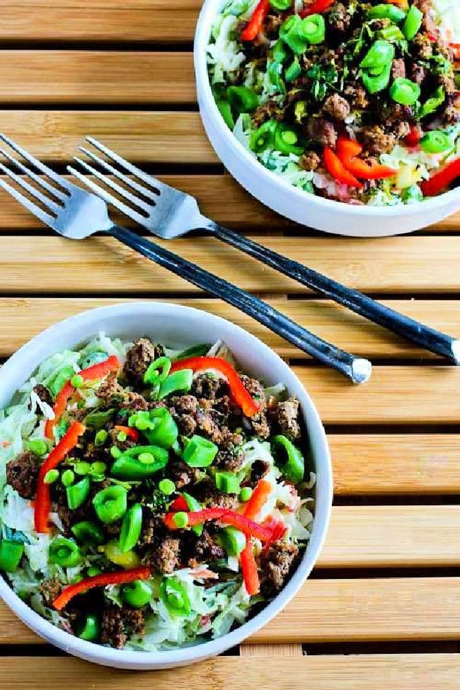 Sriracha Beef Cabbage Bowl shown in two bowls with forks.