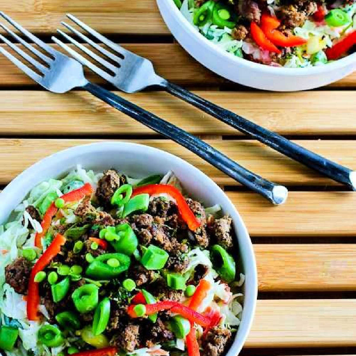 Sriracha Beef Cabbage Bowl  shown in two bowls with forks.