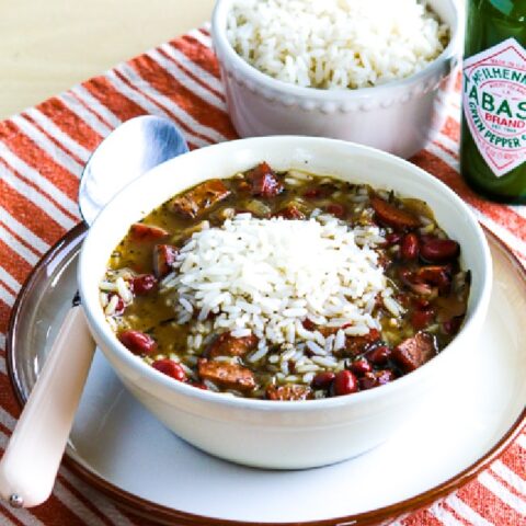 Red Beans and Rice Soup shown in serving bowl with rice and Green Tabasco Sauce