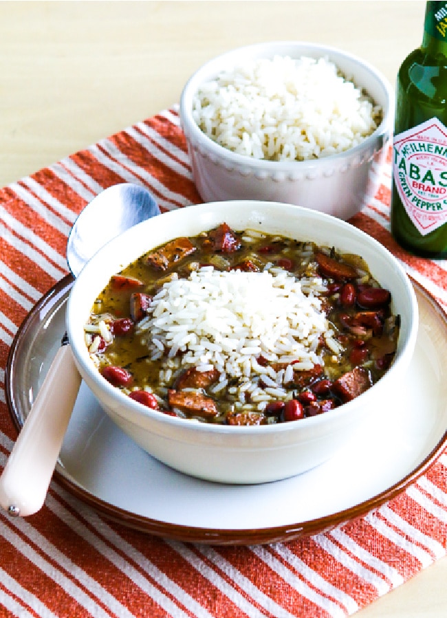 Red Beans and Rice Soup shown in serving bowl with rice and Green Tabasco Sauce