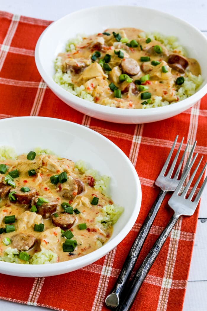 Chicken and Sausage Stew shown in two serving bowls and served over cauliflower rice