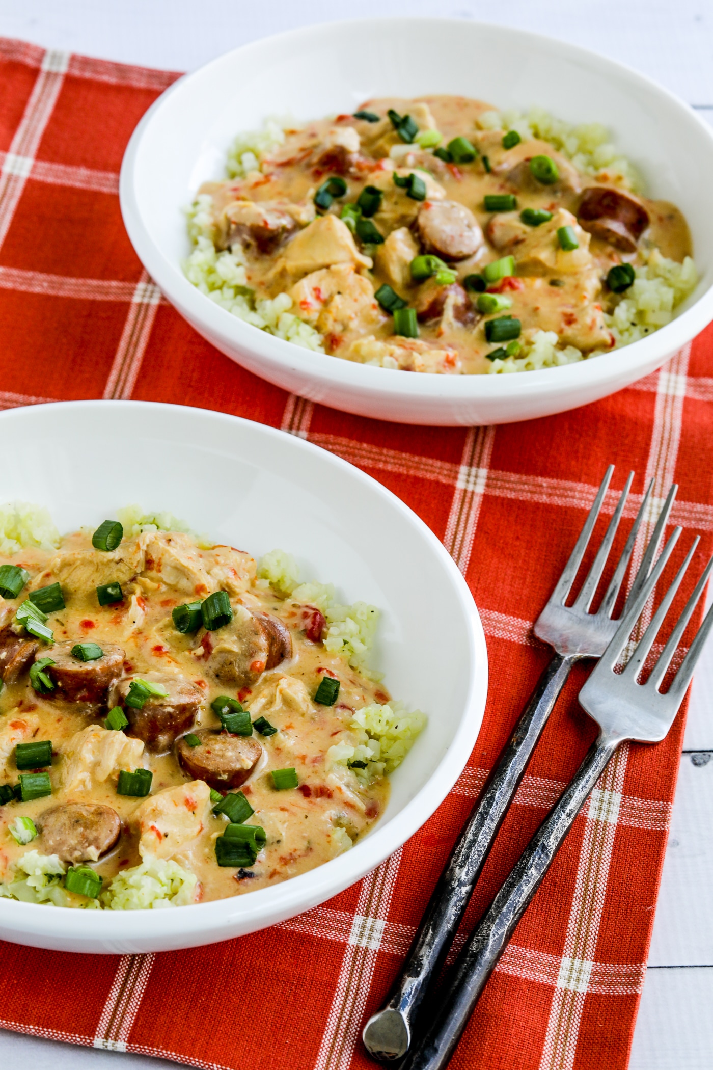 Chicken and sausage broth is offered in two serving plates and served with cauliflower rice