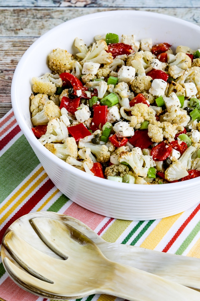 Roasted cauliflower salad with a close-up of feta, capers and red peppers