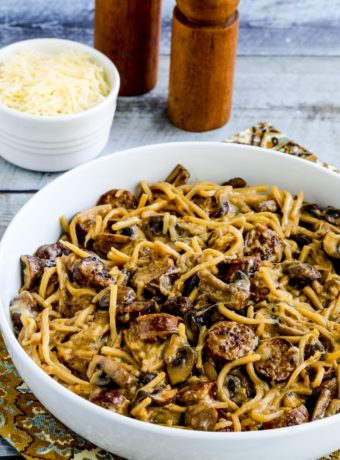 Low-Carb Pasta with Sausage and Mushrooms shown in serving dish with Parmesan