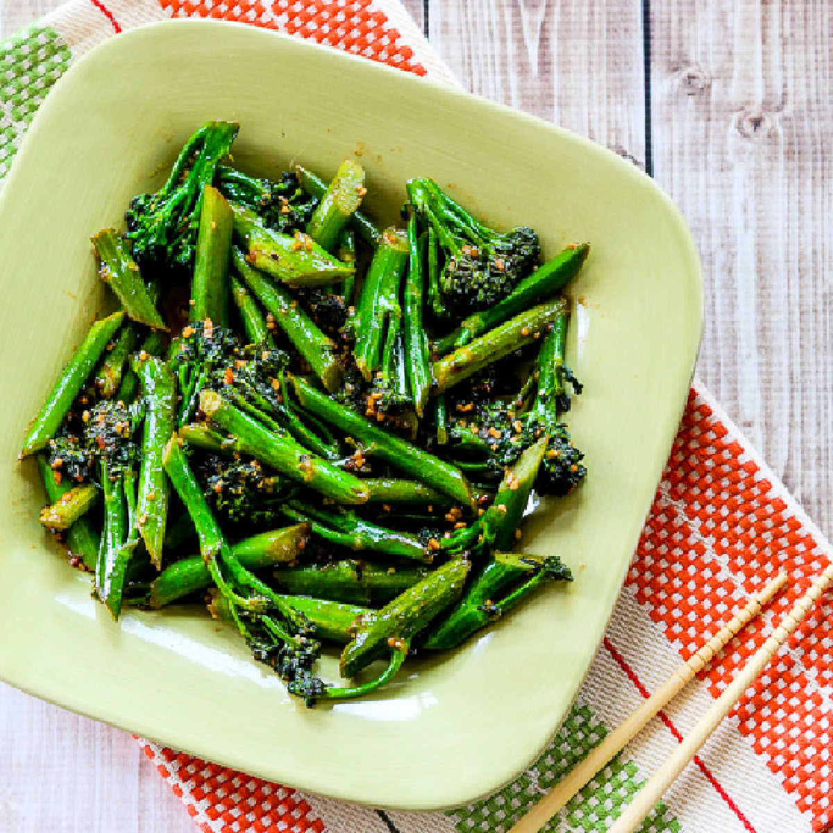 Stir-Fried Broccolini shown on serving plate with chopsticks