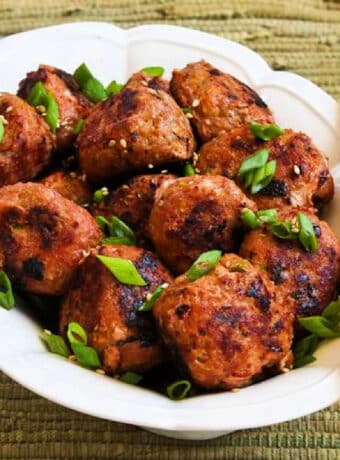Grilled Sriracha Turkey Meatballs shown on serving plate with chopsticks.