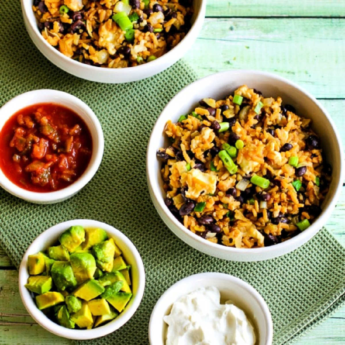 CrockPot Rice and Bean Bowl shown in two serving bowls with toppings.
