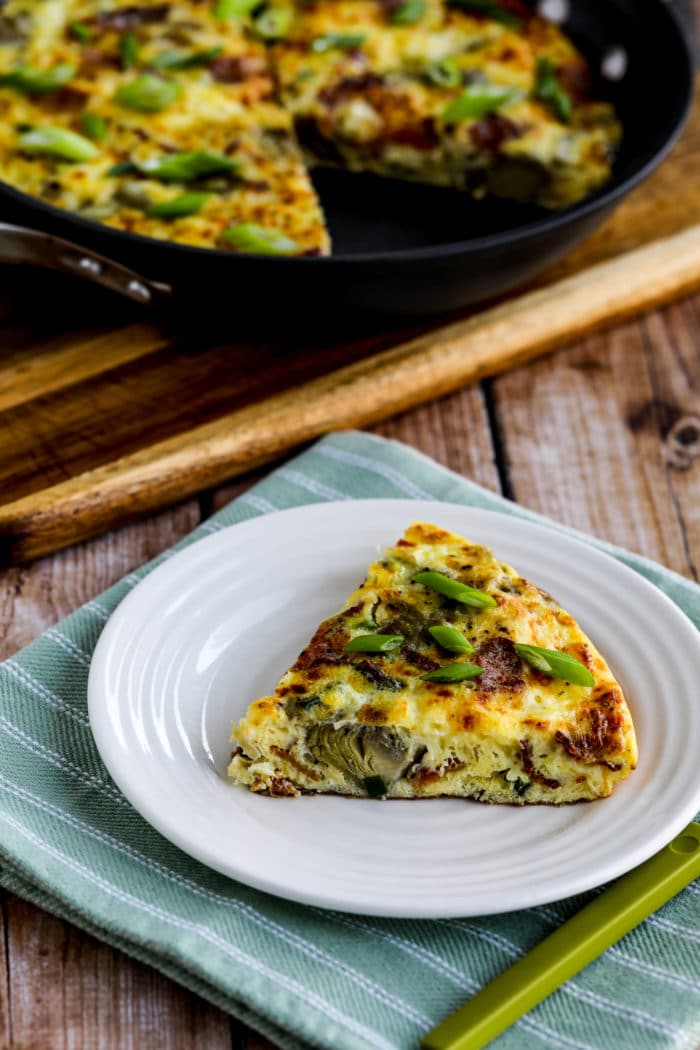 Artichoke Frittata with Bacon one slice on plate and frittata pan in background