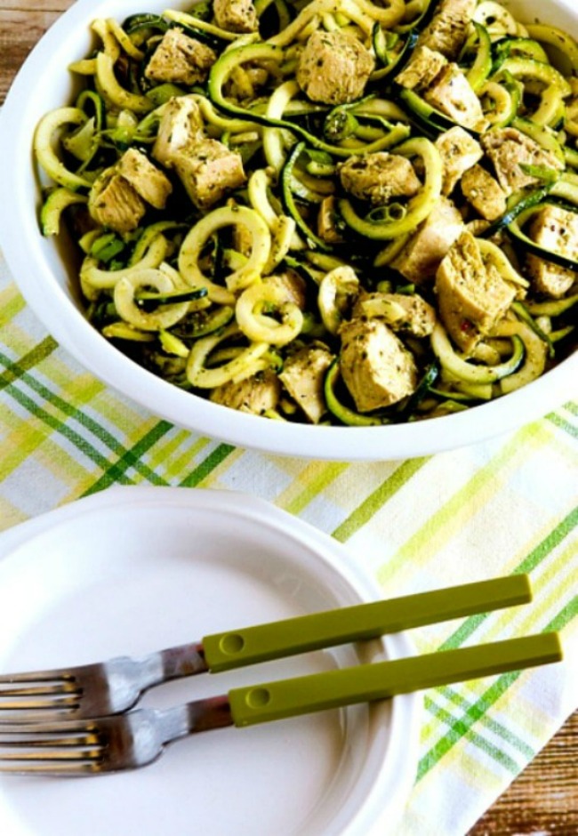 Zucchini Noodle Salad with Pesto and Chicken finished salad in bowl with plates and forks on side