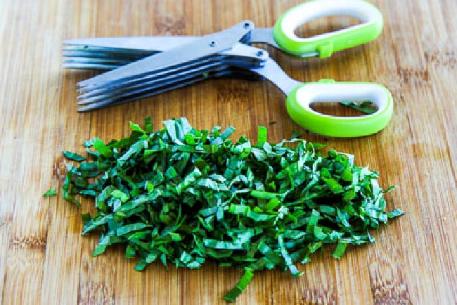 herb scissors with strips of fresh basil