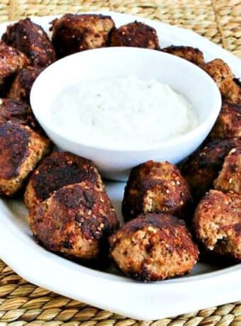 Turkey Parmesan Meatballs shown on serving platter with Tzatziki Sauce.