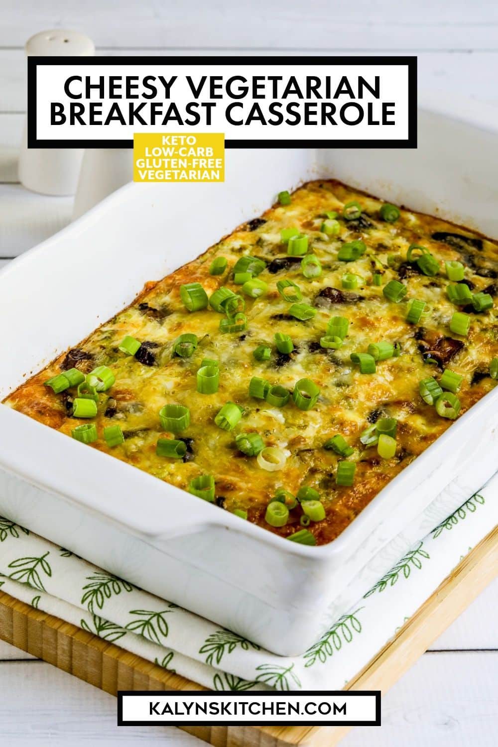 Pinterest image for Cheesy Vegetarian Breakfast Casserole shown in baking dish on napkin and cutting board.