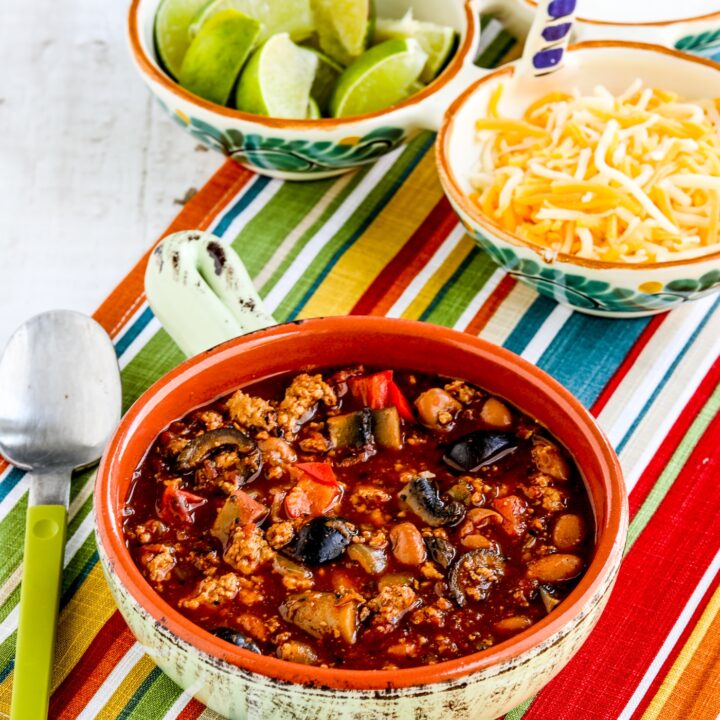Turkey Chili with Peppers, Mushrooms, and Olives finished chili in bowl with toppings