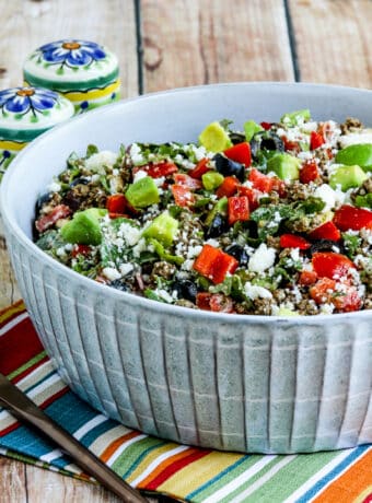 Square image of Ground Beef Taco Salad with Kale, Tomatoes, and Avocado in serving bowl.
