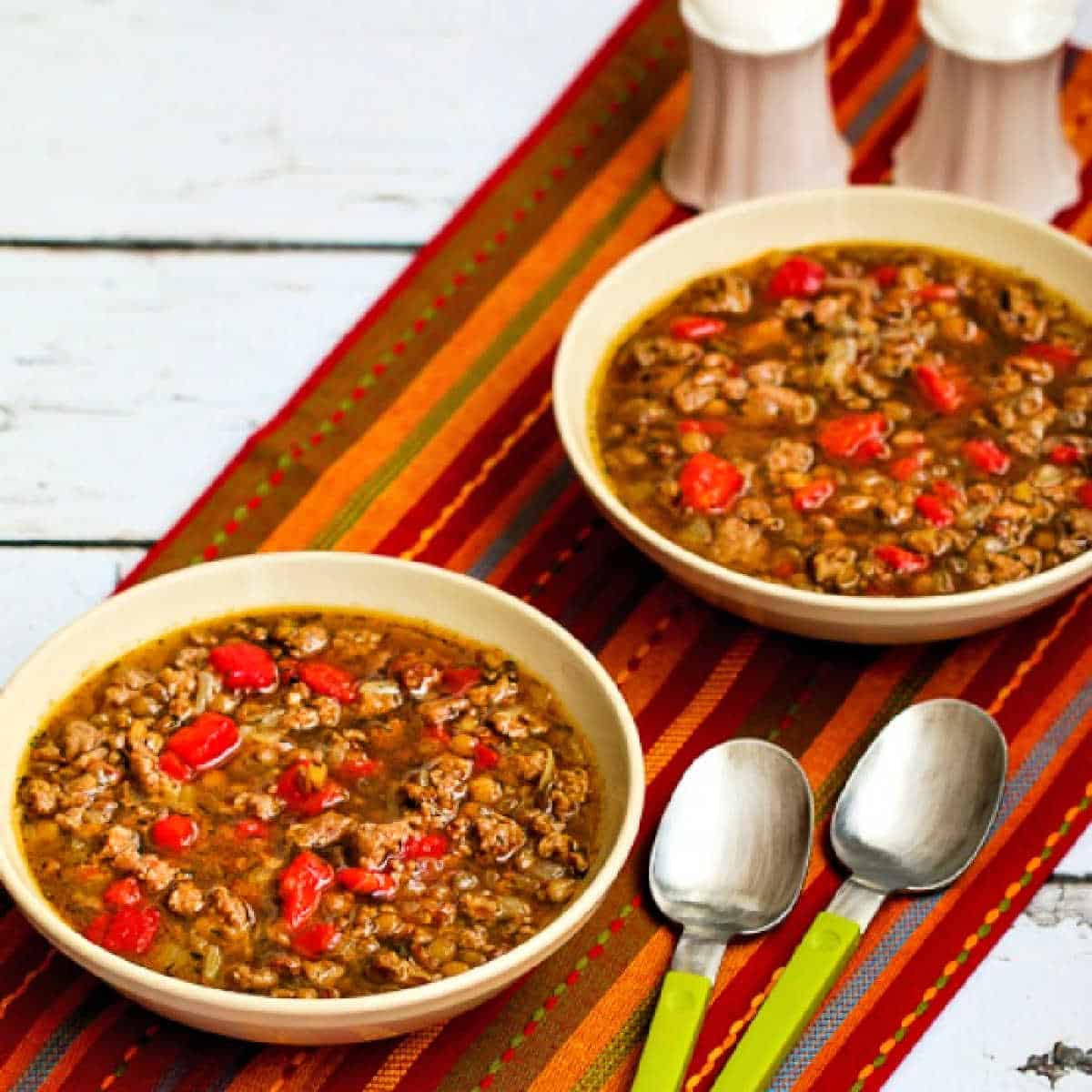square image of Sausage and Lentil Soup in two serving bowls