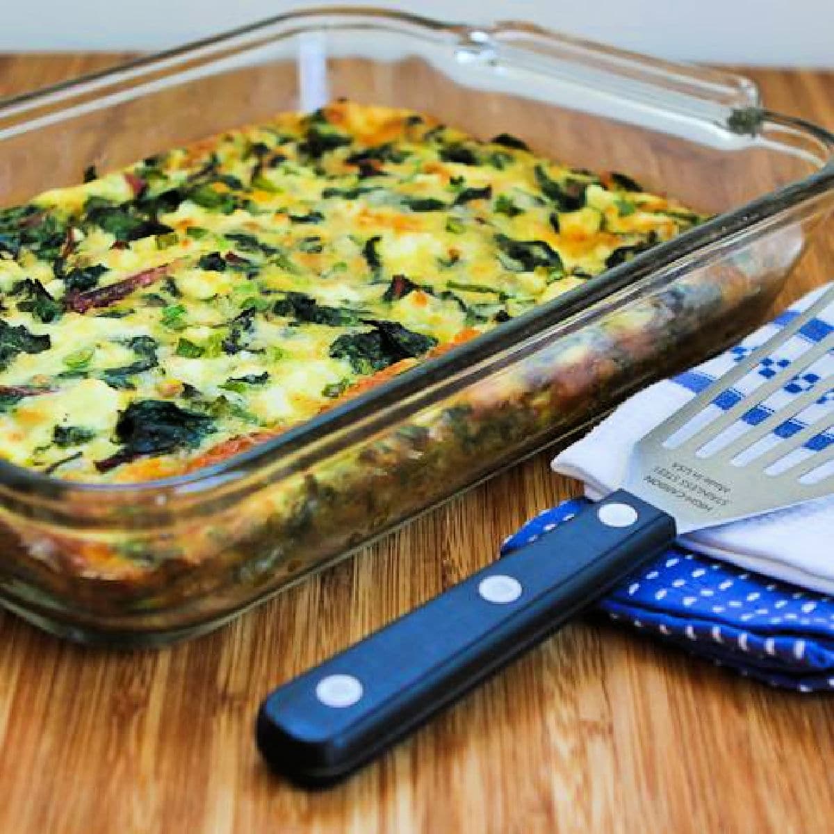 Square image for Swiss Chard, Mozzarella, and Feta Egg Bake shown in baking dish.