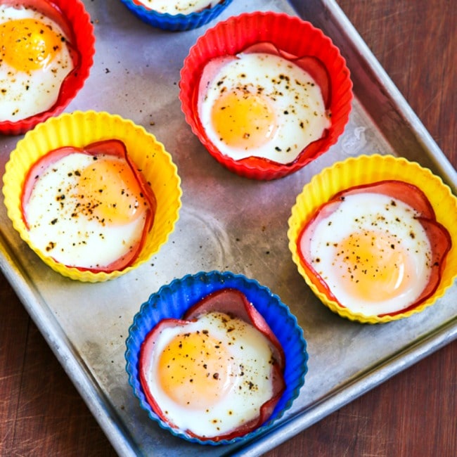 Baked Eggs in Canadian Bacon Cups square thumbnail of finished eggs