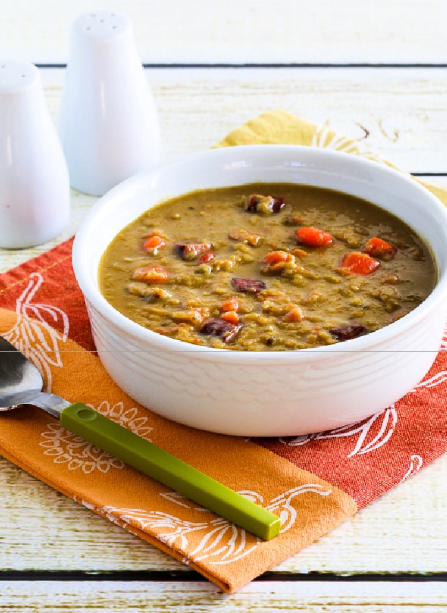 Slow Cooker Split Pea Soup in bowl with spoon and salt-pepper shakers