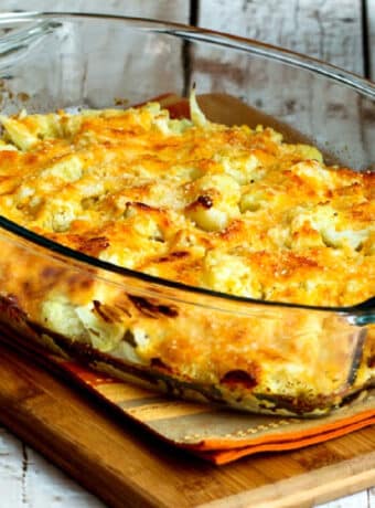square image of Cauliflower Gratin in baking dish on napkin and cutting board