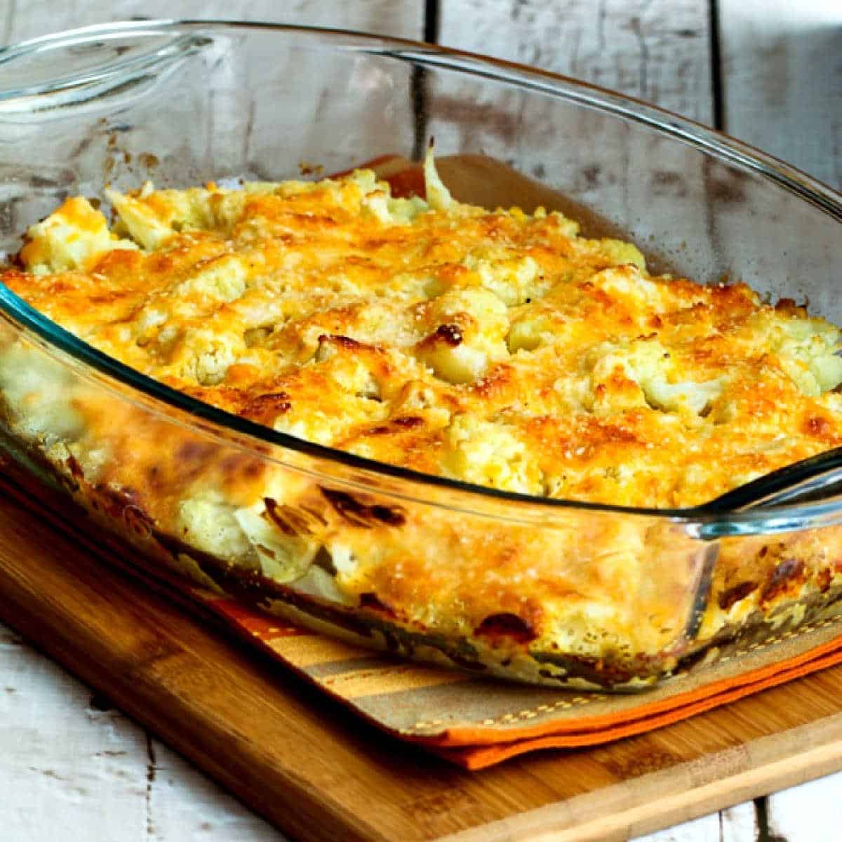 square image of Cauliflower Gratin in baking dish on napkin and cutting board