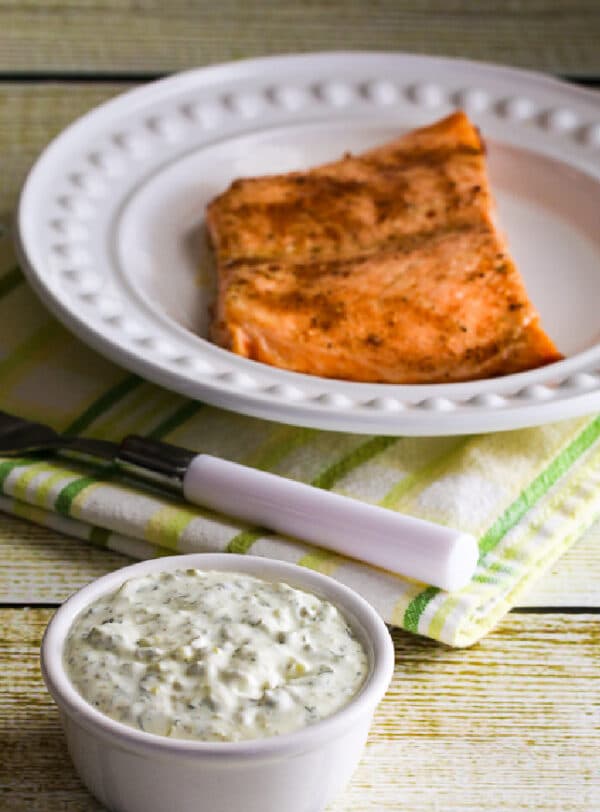 Homemade Tartar Sauce in serving bowl with salmon in background