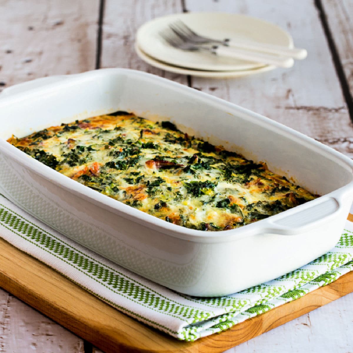 Square image for Kale, Bacon, and Cheese Breakfast Casserole shown in baking dish.