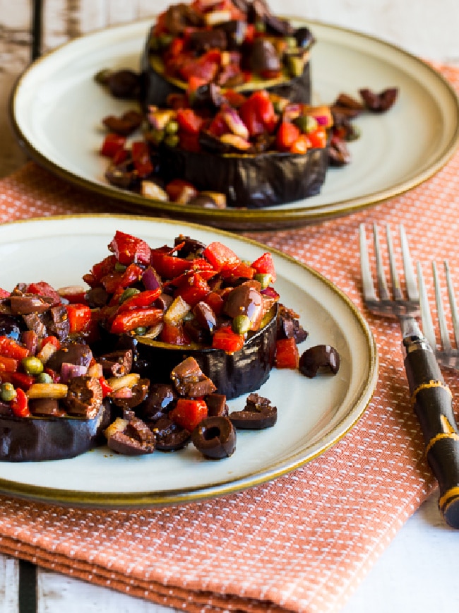 Mediterranean Eggplant on two plates with red pepper salsa