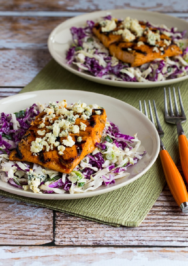 Buffalo Salmon with Blue Cheese Slaw shown on two serving plates with forks and napkin
