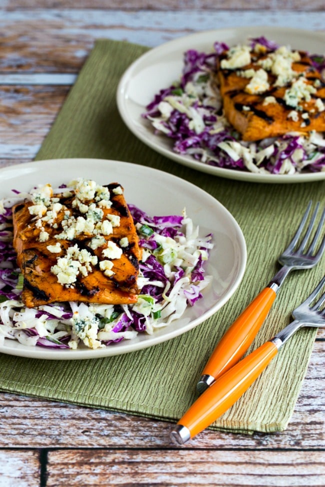 Buffalo Salmon with Blue Cheese Slaw on serving plates with forks and napkin