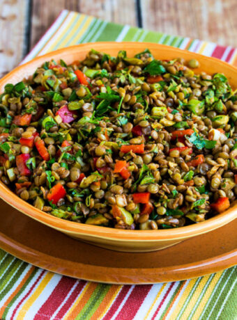 Square image of Lentil Salad with Green Olives shown in serving bowl.