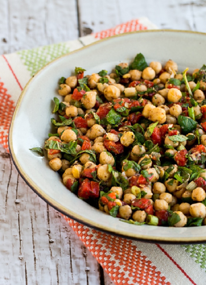 Chickpea Salad with Red Pepper, Mint, and Sumac in serving bowl on striped napkin