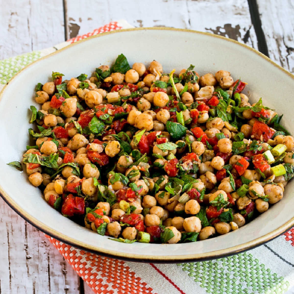 Square image of Mediterranean Chickpea Salad shown in serving bowl.