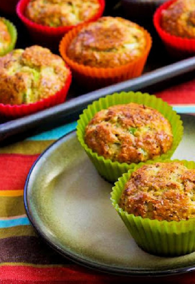 Flourless Savory Breakfast Muffins with two muffins on plate and rest in back on baking sheet.