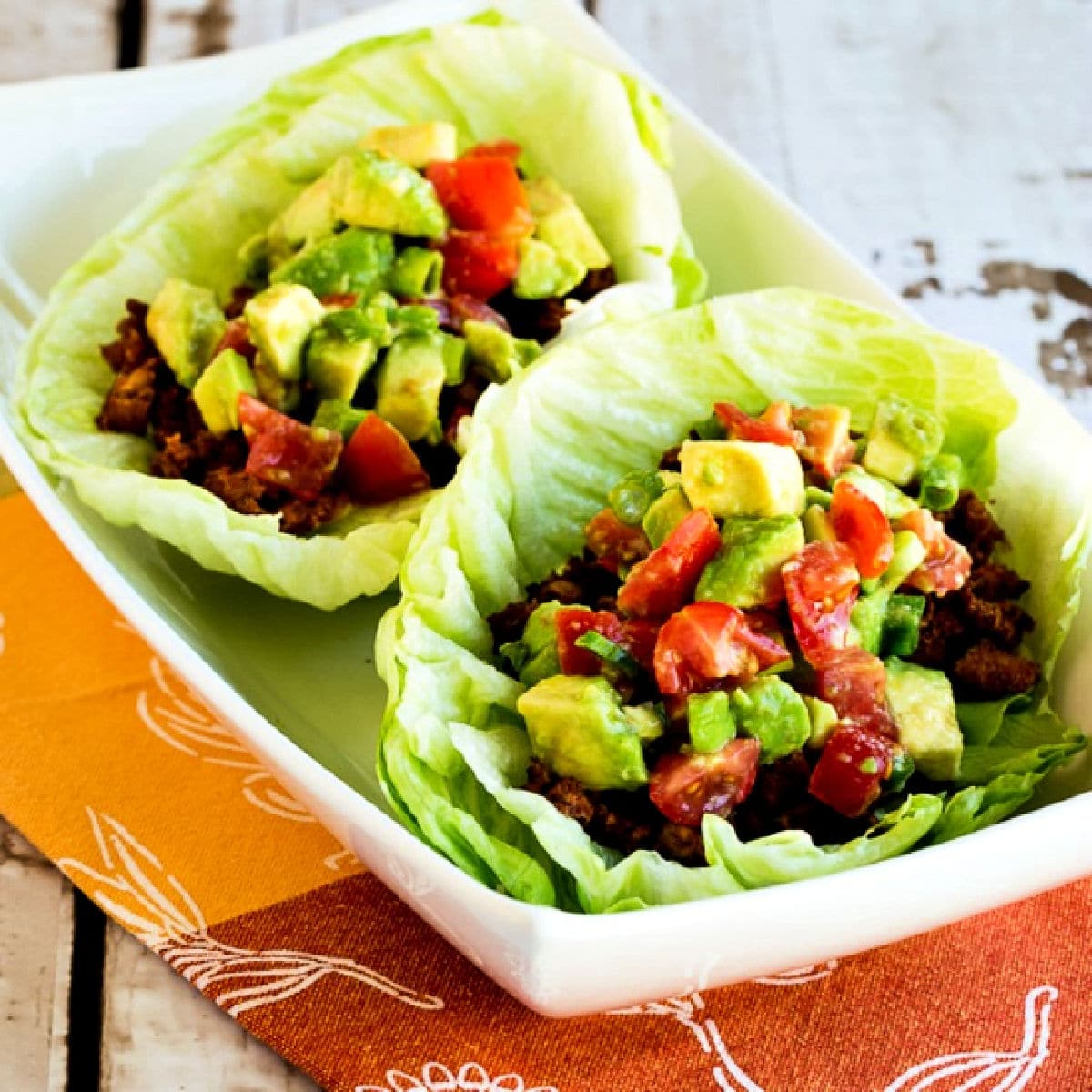 Square image of Tofu Tacos shown in lettuce wraps.