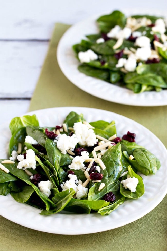 Spinach Salad with Cranberries, Almonds, and Goat Cheese finished salads on plates