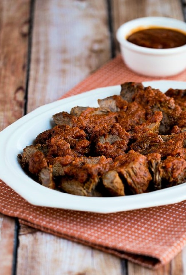 Slow Cooker Sweet and Sour Pot Roast cropped image of post roast on plate with sauce