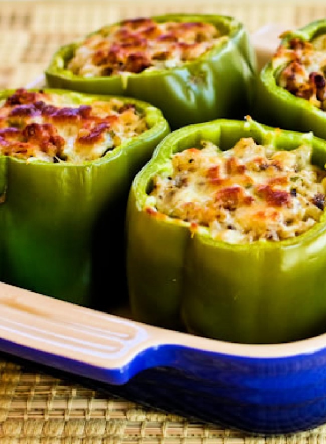 Stuffed Green Peppers with Brown Rice, Italian Sausage, and Parmesan, shown in baking dish.