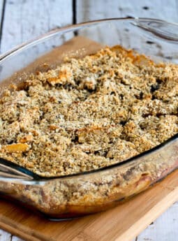 square image of Cranberry Apple Crumble shown in baking dish on cutting board