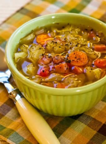 Slow Cooker Ham and Cabbage Soup square image of soup in bowl with spoon