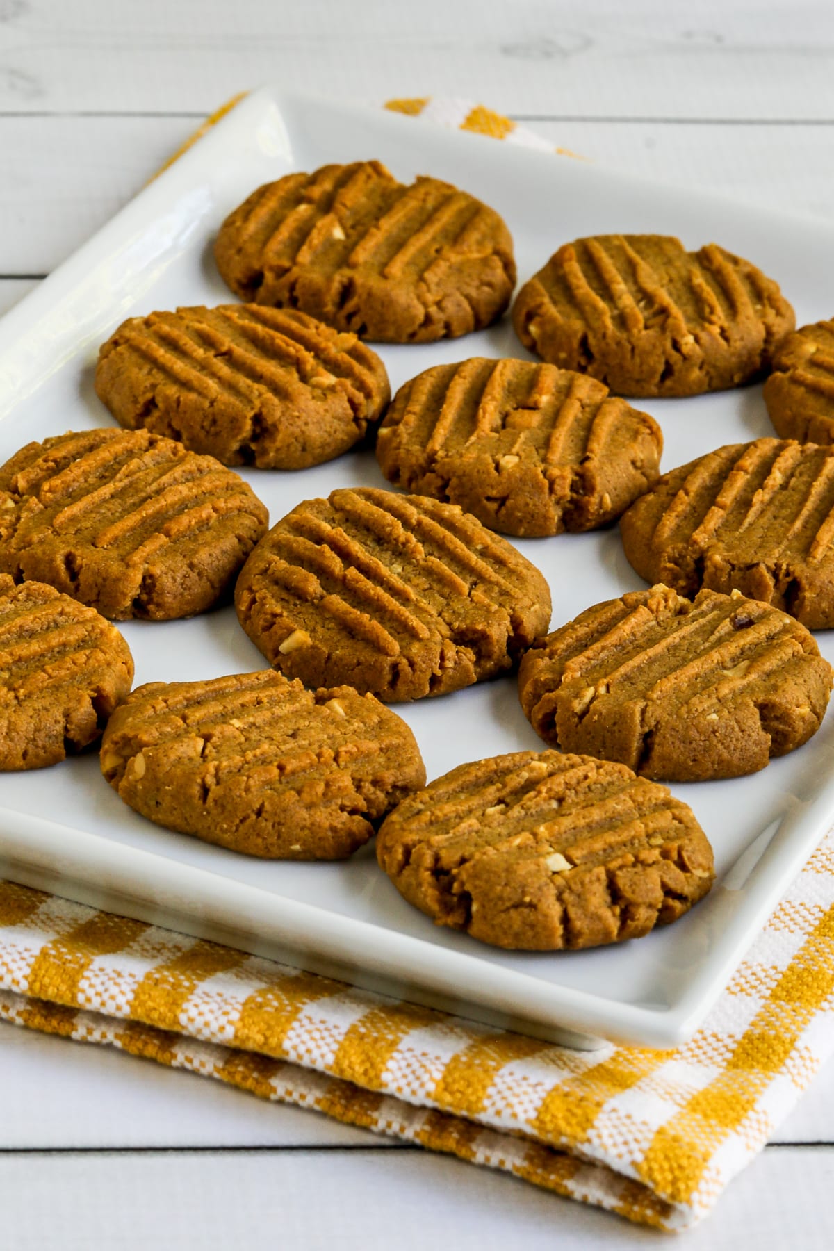 Sugar-Free Peanut Butter Cookies on serving platter with checkered napkin underneath.