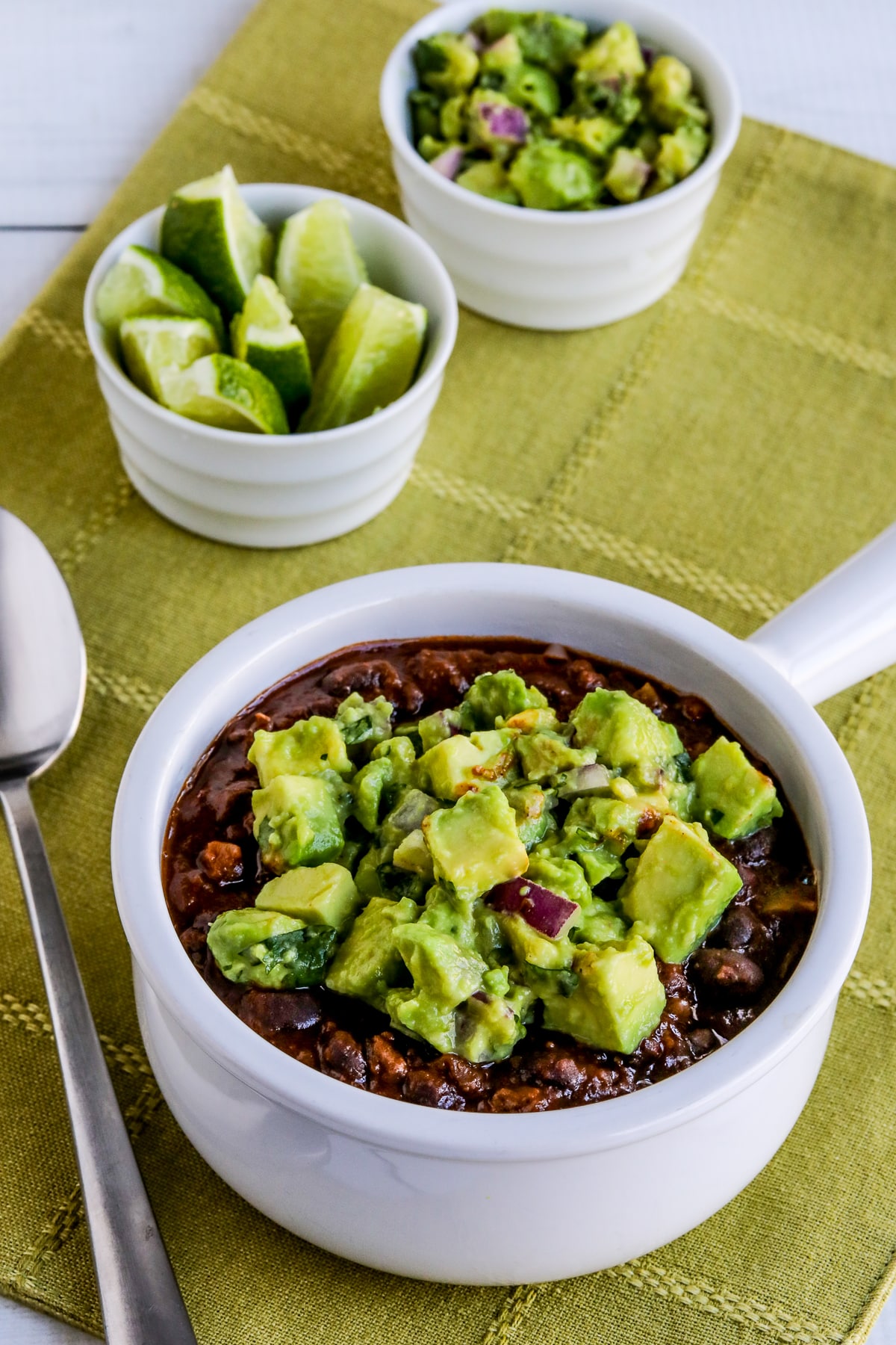 Black Bean and Beef Chili, updated photo showing chili in a bowl topped with avocado salsa.