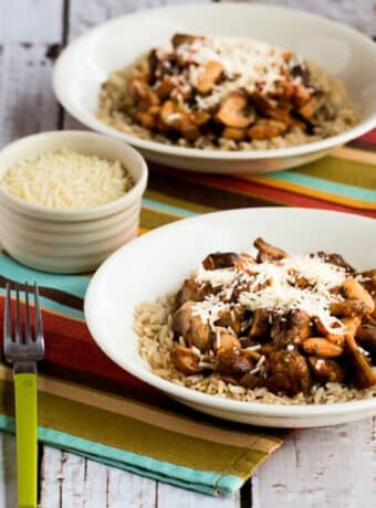 Square image for Mushroom Stew shown in two bowls with forks and Parmesan.