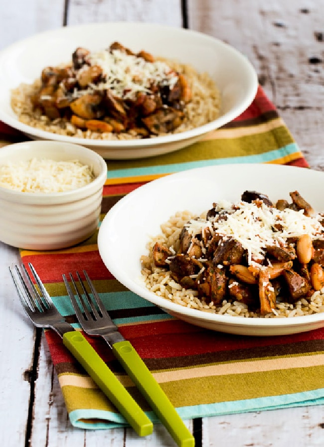 Mushroom Stew in two Bowls with spoons and Parmesan Cheese