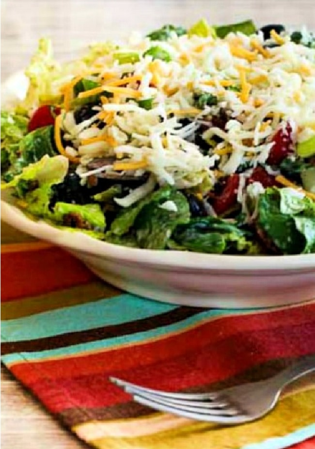 Black Bean Taco Salad in large bowl with fork and napkin.